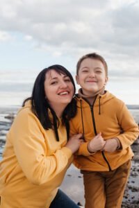 mom-son-river-bank-beautiful-girl-with-her-son-yellow-hoodies-sincerely-smile-outdoor-recreation